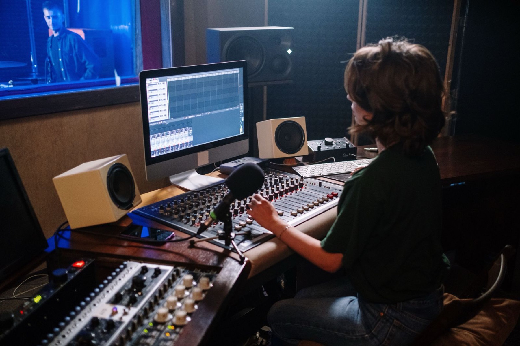 Recording studio with mixing console and screens